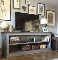 a flat screen tv sitting on top of a wooden entertainment center in a living room