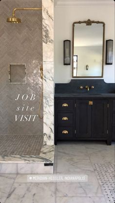 the bathroom is decorated in black and white marble with gold accents on the shower door