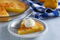 a slice of lemon pie on a plate with a fork and bowl of ice cream