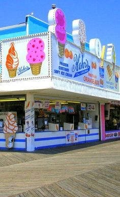 an ice cream shop is on the boardwalk