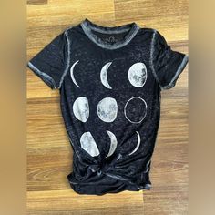 Size Xs Women’s Tee With The Moon Phases On The Front. Very Light Material. Back Is Longer Than The Front And The Material Is Semi See Through. I’ve Had The Tee With The Knot In The Front! Excellent Condition! Fitted Moon Print Crew Neck Top, Fitted Black Tops With Moon Print, Fitted Moon Print Tops For Summer, Casual Spring Tops With Moon Print, Casual Moon Print Tops For Spring, Black Moon Print Crew Neck Top, Summer Moon Print Crew Neck Top, Black Crew Neck Top With Moon Print, Black Summer Top With Moon Print