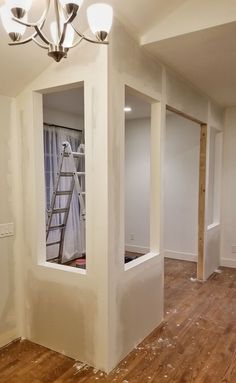 an empty room with white walls and wood floors is being painted in the process of remodeling