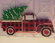 a red truck with a christmas tree on the back in front of a white background