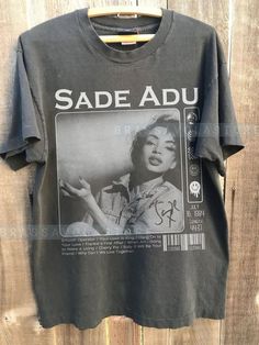 Sade Adu Graphic Black Color Shirt sold by Evandro Silva | SKU 93913776 | 50% OFF Printerval Irish Musicians, Sade Adu, Smooth Operator, Color Shirt, Graphic Shirts, Types Of Shirts, The United States, Black Tshirt, Shirt Shop