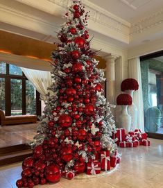 a christmas tree decorated with red and silver ornaments