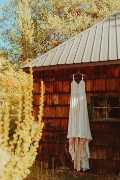 a white dress hanging on a wooden building