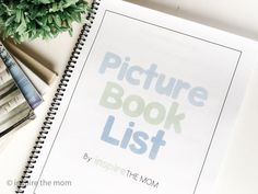 a book with the words picture book list on it next to a potted plant