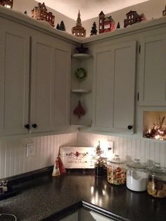 Christmas Village On Cabinets, Village Above Cabinets, Above Cabinet Christmas Village, Christmas Village Above Cabinets, Winter Decor Above Kitchen Cabinets, Fall Garland Above Kitchen Cabinets, Christmas Top Of Cabinet Decor