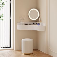 a bathroom with a mirror, stool and plant on the floor in front of it