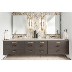 a bathroom vanity with two mirrors above it