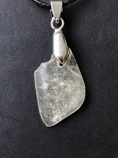 "LIBYAN DESERT GLASS - GREAT SAND SEA - EGYPT - CABOCHON PENDANT NECKLACE - AMAZING - EVERY NECKLACE IS HAND MADE AND UNIQUE. ABSOLUTELY AMAZING SPECIMEN WITH FEW NATURAL INCLUSIONS. Libyan Desert Glass cabochon necklace- LDG - Top GEM quality - completely translucent with inclusions \"free\" shape - mirror polished on both sides - 2.5 g. Picture were taken by daylight (outside). Libyan desert glass, 29 million years ago was probably formed when an asteroid or comet hit the surface of the earth Silver Drop Glass Jewelry, Silver Teardrop Glass Necklaces, Silver Glass Teardrop Jewelry, Silver Glass Drop Jewelry, Minimalist Silver Resin Jewelry, Clear Glass Pendant Jewelry, Clear Sea Glass Jewelry Gift, Oval Glass Silver Jewelry, Clear Sea Glass Jewelry For Gift