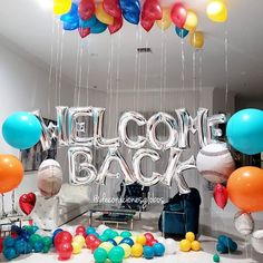 the welcome back sign is surrounded by balloons