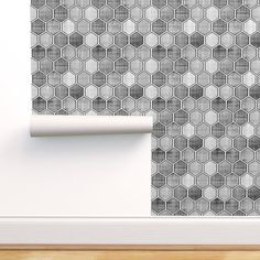 a wall with a pattern on it and a roll of paper in front of it