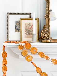 an orange garland is hanging on the mantle