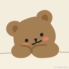 a brown teddy bear sitting on top of a bed