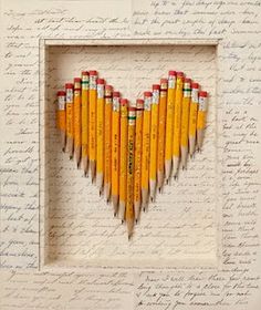 pencils are arranged in the shape of a heart