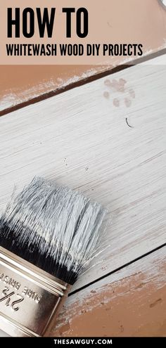 a paint brush sitting on top of a white wooden floor with text overlay that reads, how to whitewash wood diy projects