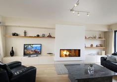 a living room with a fire place in the center