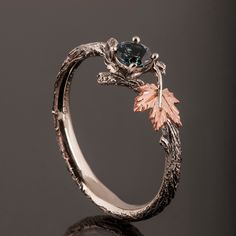 "A handmade 18k twig and leaf ring made in two gold colors and set with a beautiful, natural Montana sapphire. The grooves in the band are plated with black rhodium which emphasizes the texture. if you prefer not to apply the black rhodium that is fine. I can also use a white, rose, or yellow gold for the band and the leaves for the same price. The center stone is a 5mm natural Montana teal sapphire of high quality. Please note that the sapphires are natural stones and the exact shade may vary. Custom Rings Design Unique, Teal Sapphire Ring, Leaves Ring, Fantasy Ring, Twig Engagement Ring, Twig Ring, Leaf Engagement Ring