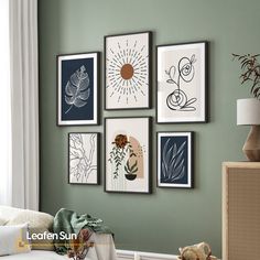 a living room with green walls and pictures on the wall, including a white couch