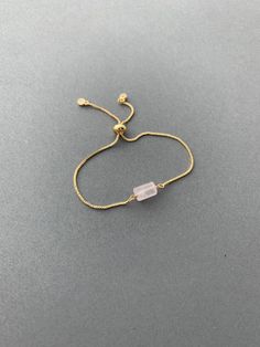 "This bracelet is a must have for your wardrobe! A rough cut gemstone bead is wire wrapped to a comfortable adjustable bracelet chain. It comes in your choice of sparkly gold, silver, or rose gold finish. It comes packaged with care in a beautiful gift box. *For more bracelets: https://www.etsy.com/shop/saraweberjewelry/?section_id=7769955 M A T E R I A L S * & * S I Z E * Natural Stone * Chain - Rose gold plated, gold plated, or rhodium plated * Length - Adjustable 5.5\" - 9\" P R O D U C T Gold Rose Quartz Bracelets For Jewelry Making, Adjustable Gold Crystal Bracelet With Gemstone, Adjustable Gold Crystal Gemstone Bracelet, Elegant Rose Quartz Crystal Bracelet For Gift, Elegant Rose Quartz Crystal Bracelet Gift, Elegant Pink Resizable Beaded Bracelets, Delicate Adjustable Crystal Bracelet With Gemstone, Adjustable Gold Rose Quartz Jewelry, Delicate Adjustable Crystal Gemstone Bracelet