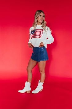 Stay stylish and show your patriotic spirit with our American Flag Sweater in ivory. This trendy and cute sweater features embroidered stars and stripes in classic red, white, and blue. Paired with THE KALEI DENIM SKORT IN DARK WASH and THE BOW SANDALS IN IVORY. Embroidered stars American flag design Round neck Ribbed collar and hem 60% cotton, 40% acrylic Fits true to size. X-Small/Small(0-2), Small/Medium (4-6), Large/X-Large (8-12) Model is 5'5" wearing a size XS/S. To view our return policy, Happy Threads, Summer Goddess, Flag Sweater, American Flag Sweater, Embroidered Stars, Pink Desert, American Flag Design, Denim Skort, Eagle Tee