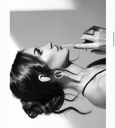 a woman is brushing her teeth with an electric toothbrush in black and white photo