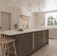 a large kitchen with two bar stools next to an island