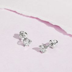 Set in a traditional jeweler's 5 prong setting, these simulated birthstone earrings are elegant and timeless. The flawless 4mm cubic zirconia stones are set entirely in 925 sterling silver, a naturally HYPOALLERGENIC fine metal. These earrings feature threaded posts and a safety back system to ensure your child's earrings stay comfortably in place. Choose your toddlers birth month stone or favorite color. A complimentary gift box is included for easy giving! Sterling Silver Birthstone Piercings, Elegant Birthstone Piercings As Gift, Classic Silver Piercings With Prong Setting, Classic White Gold Crystal Earrings As Gift, Classic White Gold Crystal Earrings For Gift, White Gold Piercings With Prong Setting As Gift, Classic Huggie Birthstone Jewelry, Wedding Sterling Silver Piercings With Prong Setting, Dainty Cubic Zirconia Birthstone Earrings