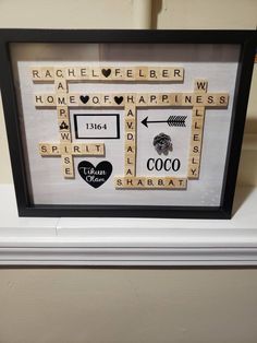 scrabble tiles are arranged in a black and white frame with the words home, happiness, birth, heart, arrow, etc