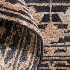 an area rug with black and white designs on it's side, close up