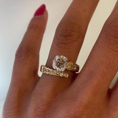 a woman's hand with a ring on it and a diamond in the middle