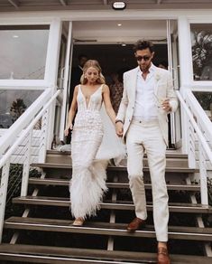 a man and woman walking down some steps