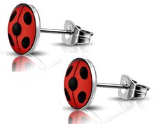 pair of red and black ladybug cufflinks on white background with reflection