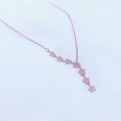 Illuminate your style with The Twinkling Stars Necklace, a celestial inspired piece crafted in Sterling Silver and plated in radiant 18K Rose Gold. Featuring seven enchanting stars, this necklace promises to make you shine wherever you go. The delicate design captures the magic of a starry night, adding a touch of celestial elegance to your every ensemble. Elevate your look and let your inner starlight shine with this captivating and timeless piece. Metal Material: Solid 925 Sterling Silver with Elegant Rose Gold Necklace With Star Charm, Rose Gold Star Necklace In Sterling Silver, Rose Gold Sterling Silver Star Necklace, Elegant Rose Gold Star Necklace, Stars Necklace, A Starry Night, Twinkling Stars, Delicate Design, Metal Material