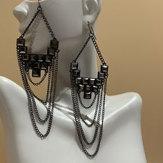 Hook Style With Plastic Fasteners. Geometric Faceted Stones In Center Four Various Length Chains Drape Bottom. Unworn Condition. Pics Taken With And Without Flash. Both Earrings With Fasteners Weigh 0.7 Ounces Gray Drop Earrings For Party, Edgy Metal Earrings For Party, Edgy Metal Party Earrings, Black Jewelry With Adjustable Chain For Night Out, Party Earrings With Adjustable Chain, Edgy Dangle Earrings For Party, Metal Chandelier Earrings With Adjustable Chain For Party, Gray Dangling Jewelry For Parties, Trendy Earrings With Adjustable Chain For Party