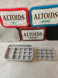 three altoids tins sitting next to each other