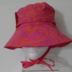 Juicy Couture Women's Printed Bucket Hat Pink Features A Fun Wavy Print Pink And Orange Designs Adjustable Neck Tie Gold Tone Hardware One Size Trendy Pink Bucket Hat With Short Brim, Pink Adjustable Cap, Adjustable Pink Cap, Trendy Pink Sun Hat, Trendy Pink Bucket Hat With Curved Brim, Trendy Pink Adjustable Sun Hat, Casual Pink Sun Hat For Festivals, Pink Adjustable Bucket Hat With Short Brim, Adjustable Pink Bucket Hat