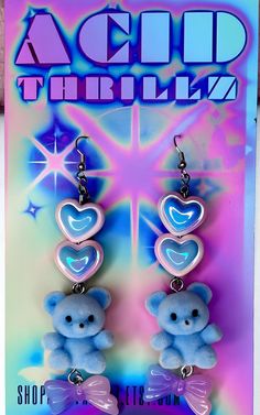 Add a touch of pastel goth cuteness to your outfit with these unique Blue Fuzzy Teddy Bear Kawaii Dangle Earrings! Featuring adorable heart beads and a sweet bow charm, these earrings are perfect for anyone who loves all things kawaii and cute. Stand out from the crowd with these one-of-a-kind accessories that are bound to make you smile every time you wear them. These handmade dangle earrings feature Cute AF fuzzy blue teddy bears adorned with pastel hearts and bows as sweet as candy. Get your Handmade Blue Kawaii Jewelry, Kawaii Heart Earrings For Valentine's Day, Blue Kawaii Earrings For Gift, Cute Blue Earrings For Valentine's Day, Cute Blue Jewelry With Heart Charm, Cute Blue Jewelry With Heart Beads, Cute Blue Jewelry For Valentine's Day, Trendy Blue Heart Earrings For Gift, Valentine's Day Kawaii Heart Earrings