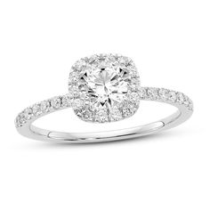 an oval shaped diamond ring with pave set shoulders