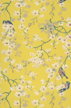 a yellow wallpaper with birds and flowers on the branches in front of white blossoms