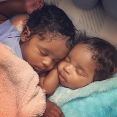 two small children sleeping next to each other