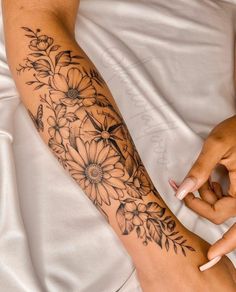 a woman with a flower tattoo on her arm