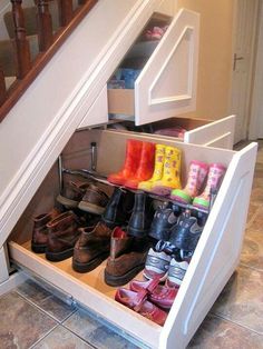 an under the stairs shoe rack holds many pairs of shoes