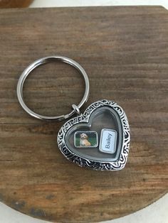 a heart shaped keychain sitting on top of a wooden table