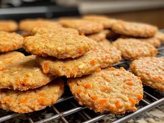 carrot cookies are cooling on a rack in the kitchen, ready to be eaten or eaten