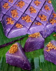 purple desserts are arranged on a banana leaf