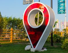 there is a large red and white marker in the grass