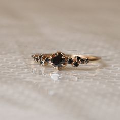 a gold ring with black stones on it