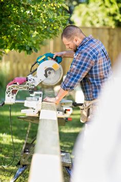 a man using a circular saw to cut wood